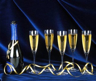 Bottle and Glasses of Champagne against Blue Background