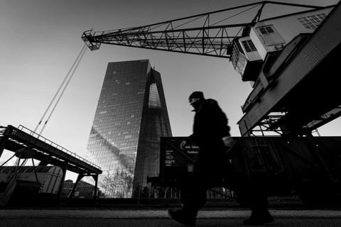 An old harbour crane frames the headquarters of the European Central Bank (ECB) in Frankfurt am