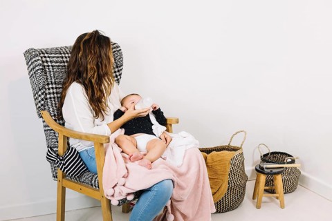 Mother feeding baby nursery