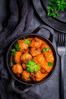 Meatballs with tomato sauce in black pan