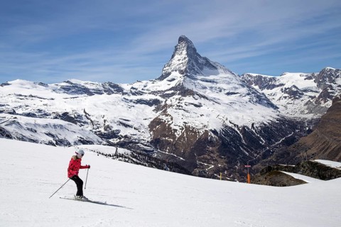 Zermatt, Switzerland, April 12, 2017: A woman skiing in front of the famous Matterhorn, Europe