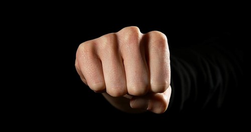 Woman's Fist against Black Background