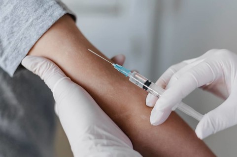 Doctor giving little patient vaccine