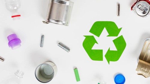 Recycling icon around different litter