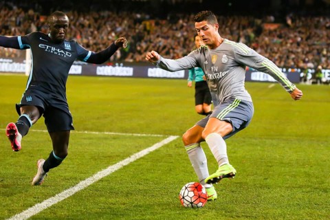 MELBOURNE, AUSTRALIA, JULY 24: Bacary Sagna and Cristiano Ronaldo tussle for the ball as Manchester