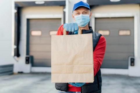 Medium shot man holding paper bag