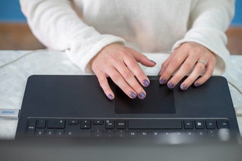 Brunette blogger writing laptop