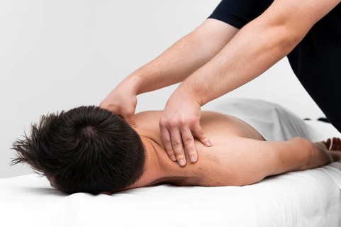Physiotherapist massaging man s back