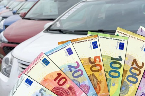 Purchase price for a car - euro banknotes with cars in the background. Purchase price for a car -