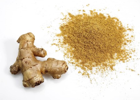 Ginger (zingiber officinale) Powder and Root against White Background
