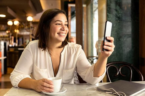 Pretty teenager browsing her mobile phone