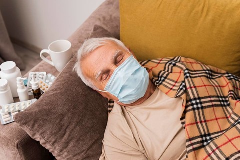 High angle man sleeping with mask