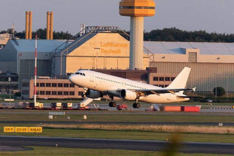 Passenger aircraft Airbus A320-214 of GetJet Airlines taking off in the evening light at Hamburg