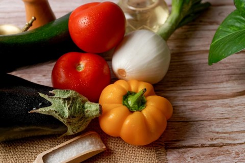 Top view of a group of fresh assorted vegetables to prepare a vegetarian menu, bell pepper, onion,