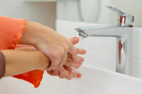 Little kids washing their hands close up