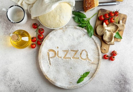 Top view pizza dough with mushrooms tomatoes word written flour