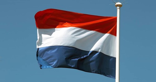 Netherlands Flag Waving in the Wind against blue sky