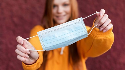 Woman holding medical mask