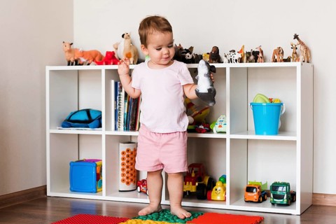 Front view happy cute baby boy playing with toys