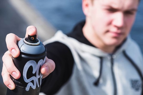 Close up man s hand holding aerosol spray can