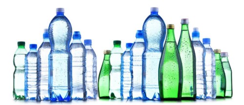 Composition with different sorts of bottles containing mineral water isolated on white