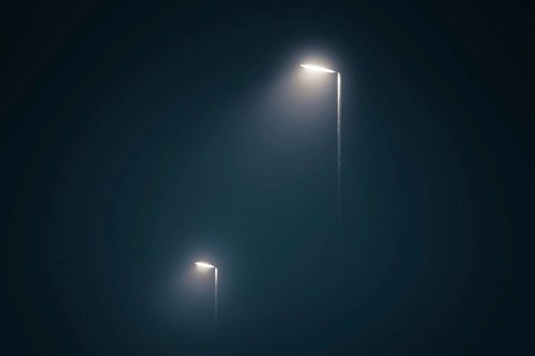 Street lights in the misty evening glowing in the dark by midnight