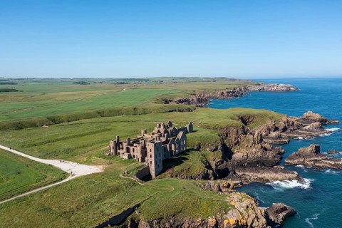 Cruden Bay, United Kingdom - 23 June, 2022: drone view of Slains Castle and the wild coast of