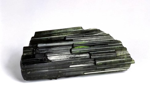 Green tourmaline stone against white background