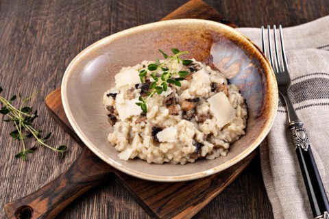 Risotto with porcini mushroom on wooden table