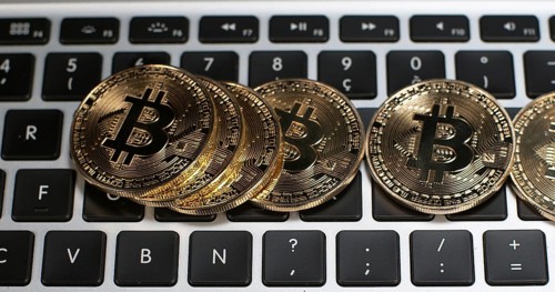 Bitcoins on Computer Keyboard Background