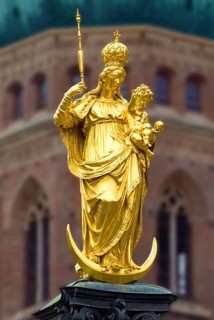 Golden Statue of Virgin Mary with Jesus as a child, a tower of catholic church Liebfrauendom or