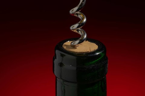 Green wine bottle with cork and corkscrew, bottle opener, decoration, open