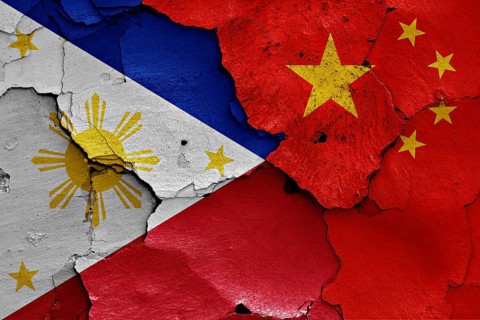 Flags of Philippines and China painted on cracked wall