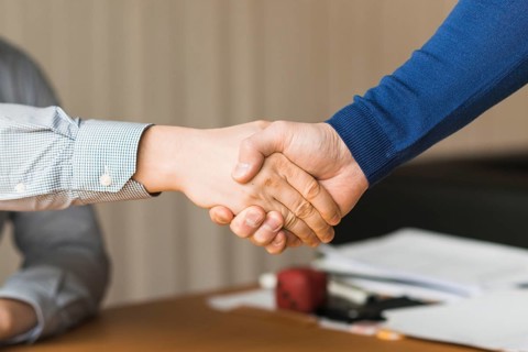 Unrecognizable businessmen handshaking
