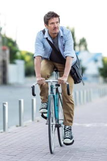 Portrait man riding bicycle city