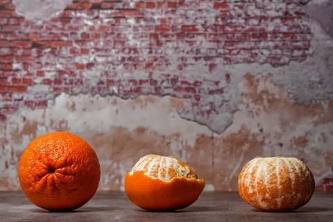 Close-up of whole, peeled tangerines (oranges) (mandarins) (clementines) (citrus fruits) on a table