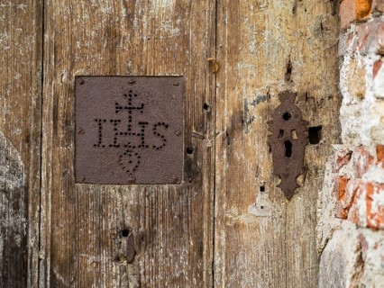 IHS, symbol of the Jesuits, detail of a gate, cemetery near the church of St. Jacob, Leoben,