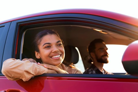 Smiley couple traveling by car