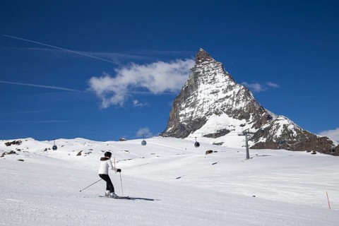 Zermatt, Switzerland, April 12, 2017: A woman skiing in front of the famous Matterhorn, Europe