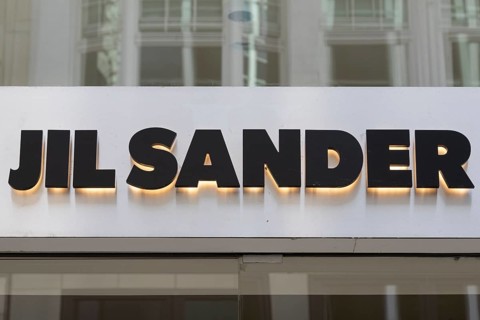 Close-up, logo of the German luxury fashion brand Jil Sander on a boutique in the shopping street