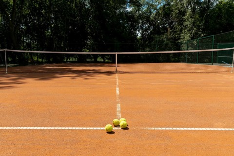 Tennis court with tennis balls ground