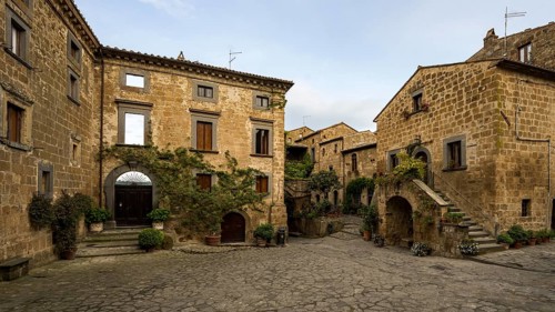 Old tufa buildings decorated with flowers in the hilltop village of Civita di Bagnoregio, Lazio,