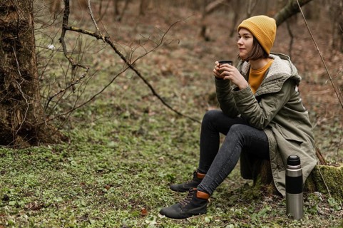 Full shot woman sitting grass