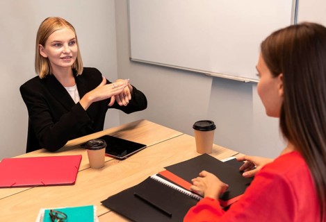 Businesswomen using sign language