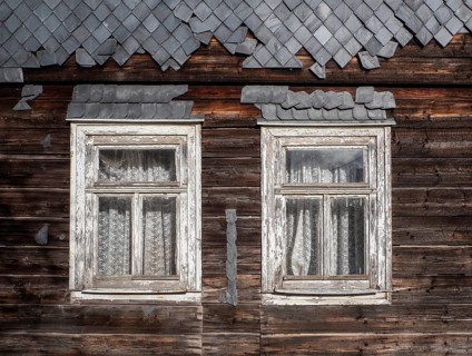 Weathered wooden windows with curtains on a wooden house with slates in the Vessertal, Breitenbach,