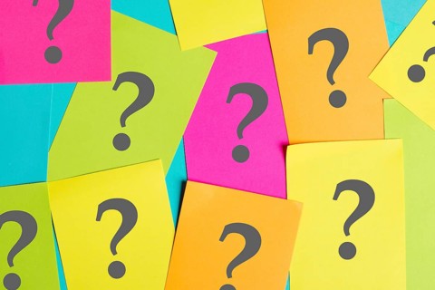 Question marks on colorful paper, looking for an answer, searching for knowledge, problem solving