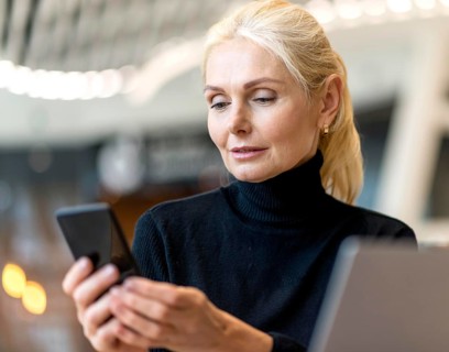 Front view elder business woman working laptop smartphone