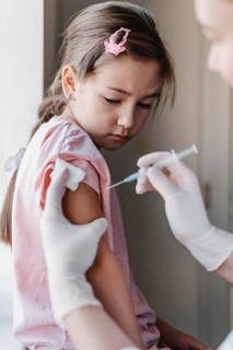 Little child with doctor getting vaccine