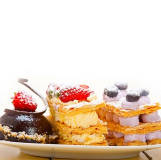 Selection of fresh cream napoleon and chocolate mousse cake dessert plate