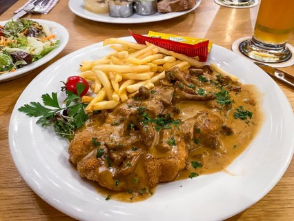 Creamed schnitzel with chanterelles, French fries, ketchup, mayonnaise, parsley, Hesse, Germany,